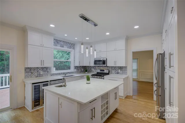 a large white kitchen with a large window