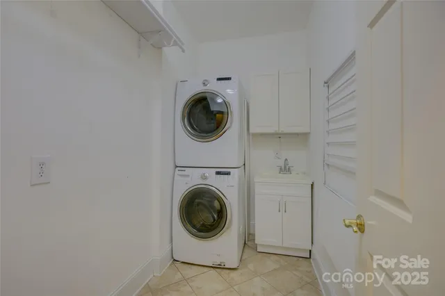 a view of a hallway with stairs and door