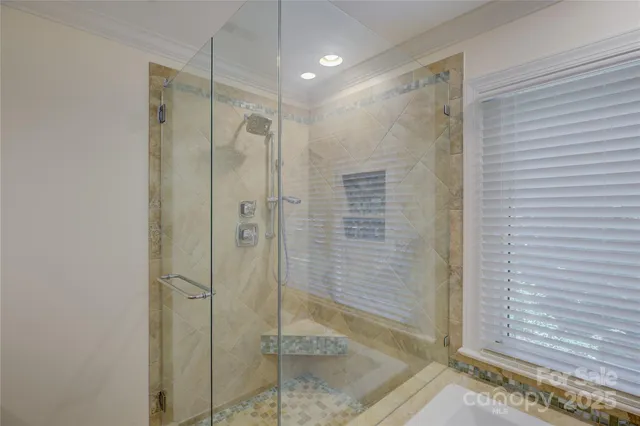 a bedroom with a bed next to a window