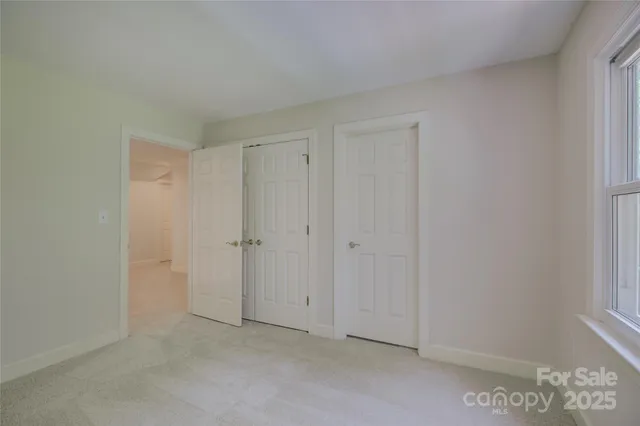 a view of staircase with two chair and a window