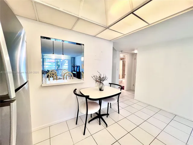 a view of a room with a table and chairs