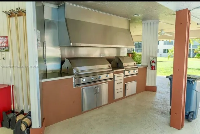 a room with pool table and windows