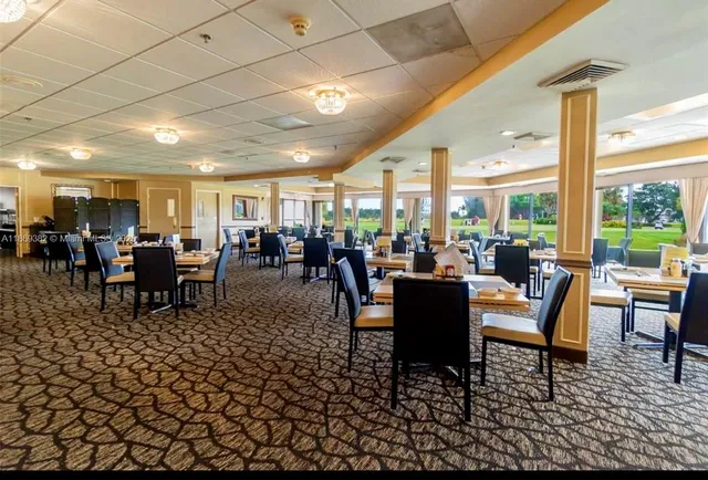 a kitchen with stainless steel appliances kitchen island granite countertop a sink and cabinets