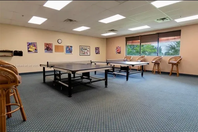 a living room with furniture and a book shelf