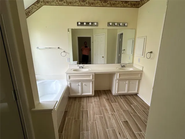 a bathroom with a sink a mirror and a bathtub