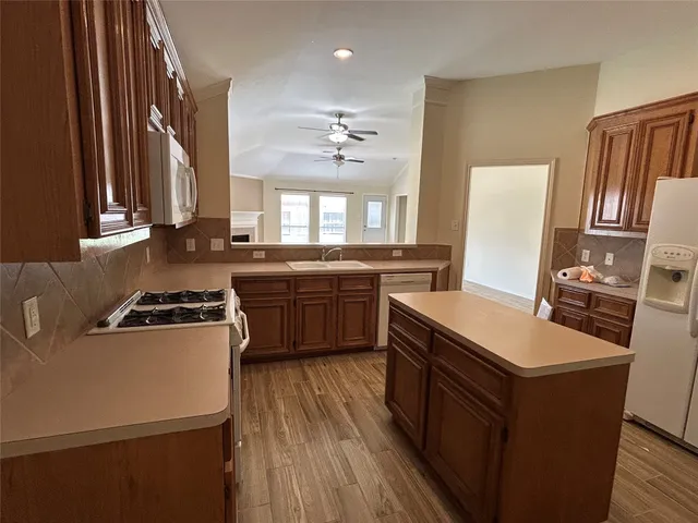 a kitchen with a stove a sink and a refrigerator