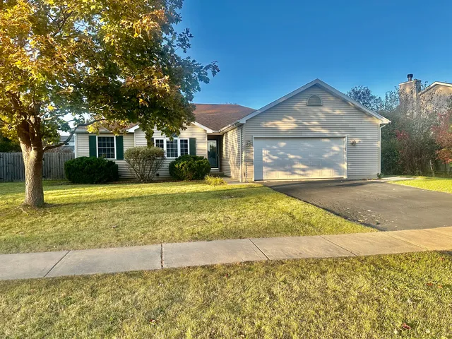 a view of a brick house with a yard