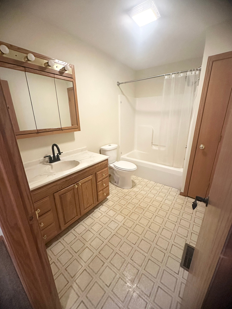 1151 Mary Court DeKalb, IL 60115 - Photo 11 of 20 a bedroom with a sink and a mirror