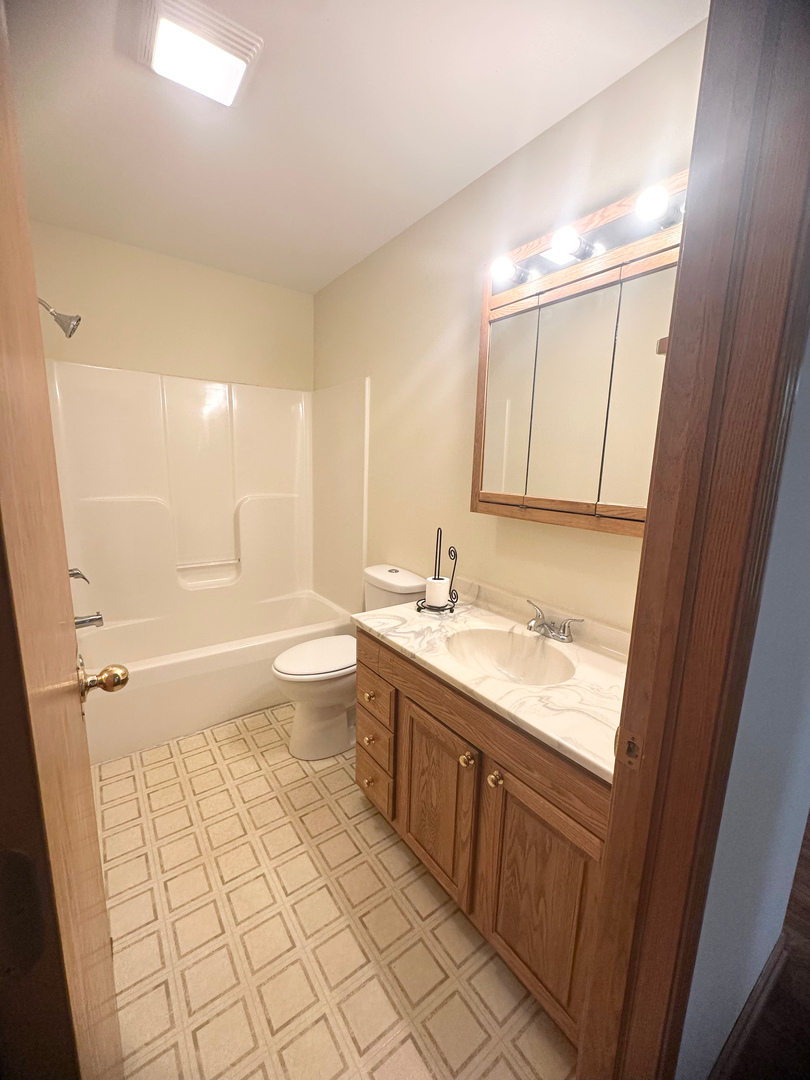 1151 Mary Court DeKalb, IL 60115 - Photo 8 of 20 a bathroom with a granite countertop sink toilet and shower