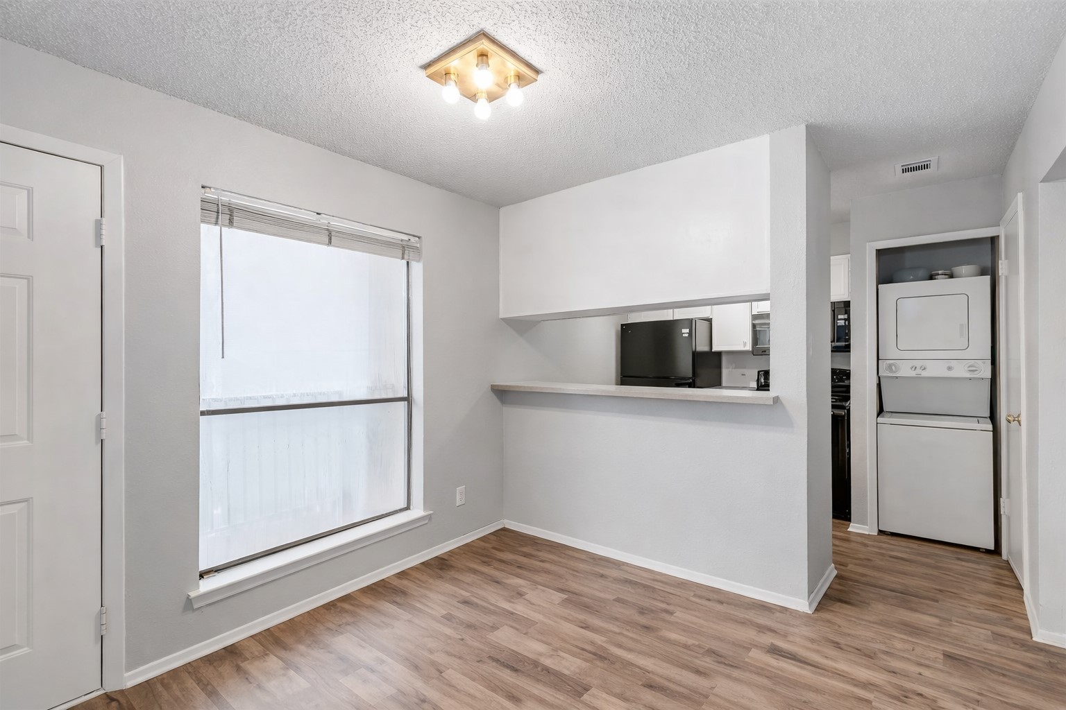 3115 Helms Street, Unit 210 Austin, TX 78705 - Photo 15 of 17 a view of kitchen and wooden floor