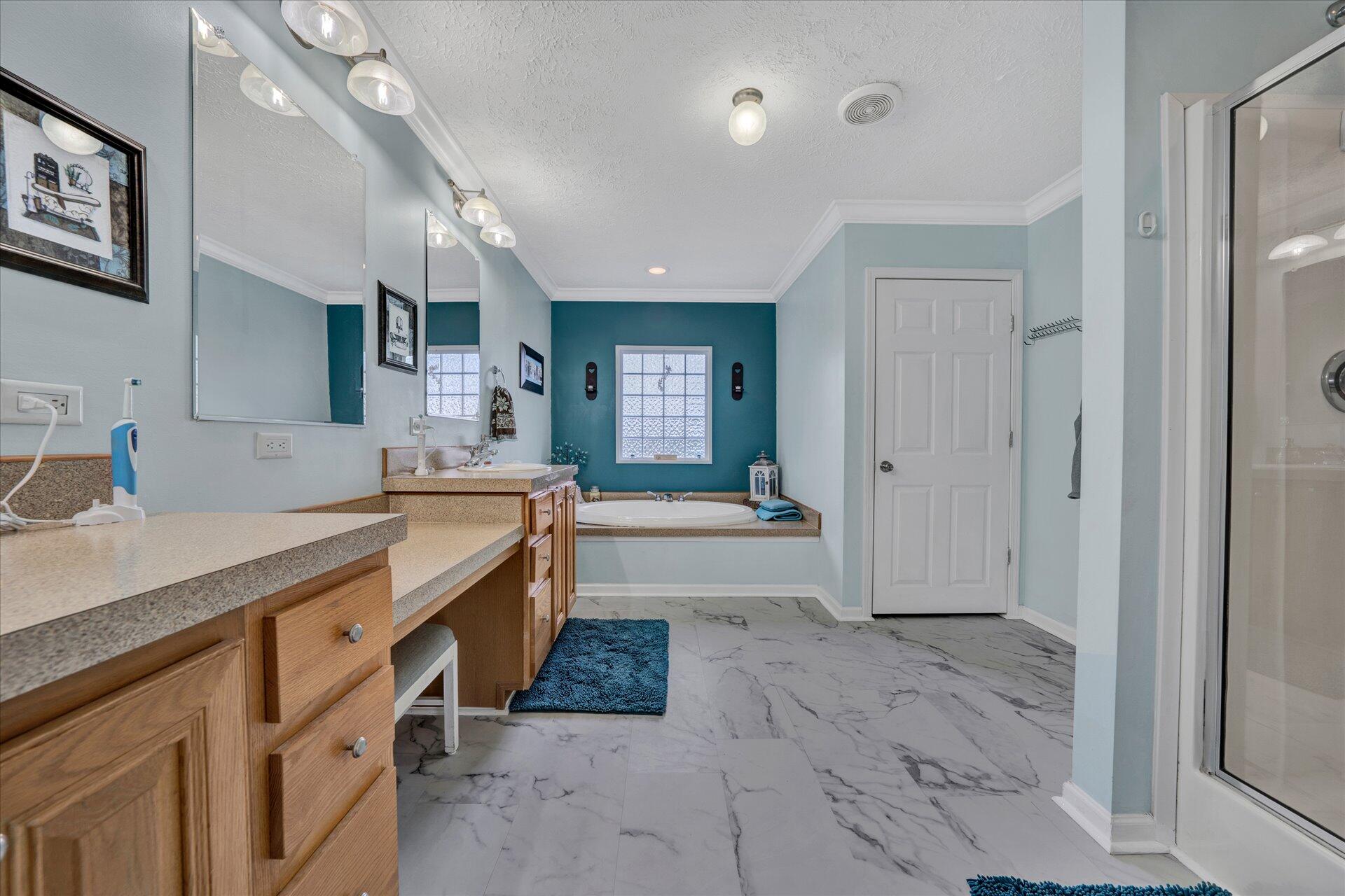 2220 Callaway Road Rocky Mount, VA 24151 - Photo 13 of 22 a large bathroom with a granite countertop double vanity sink a mirror and a