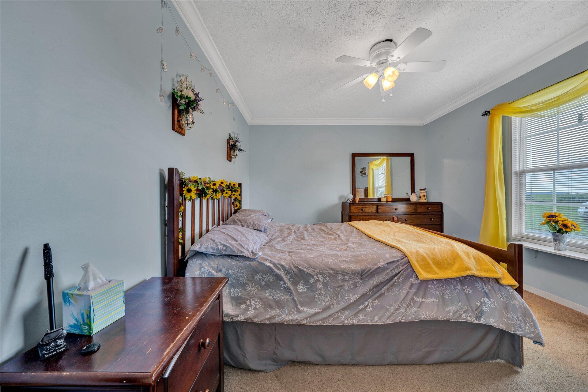 2220 Callaway Road Rocky Mount, VA 24151 - Photo 16 of 22 a bedroom with a bed and a chandelier