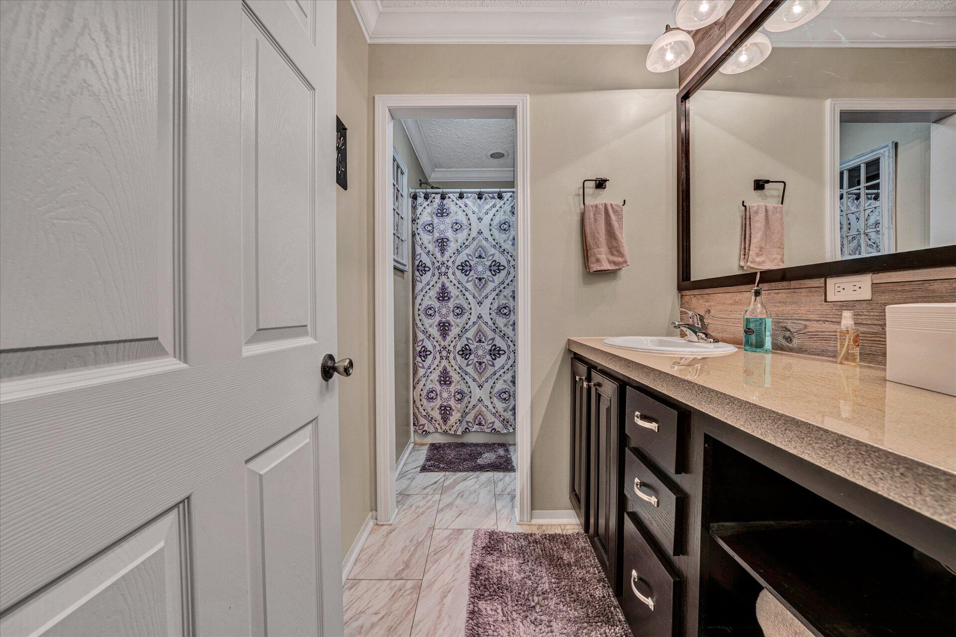 2220 Callaway Road Rocky Mount, VA 24151 - Photo 17 of 22 a bathroom with a sink a vanity and a mirror