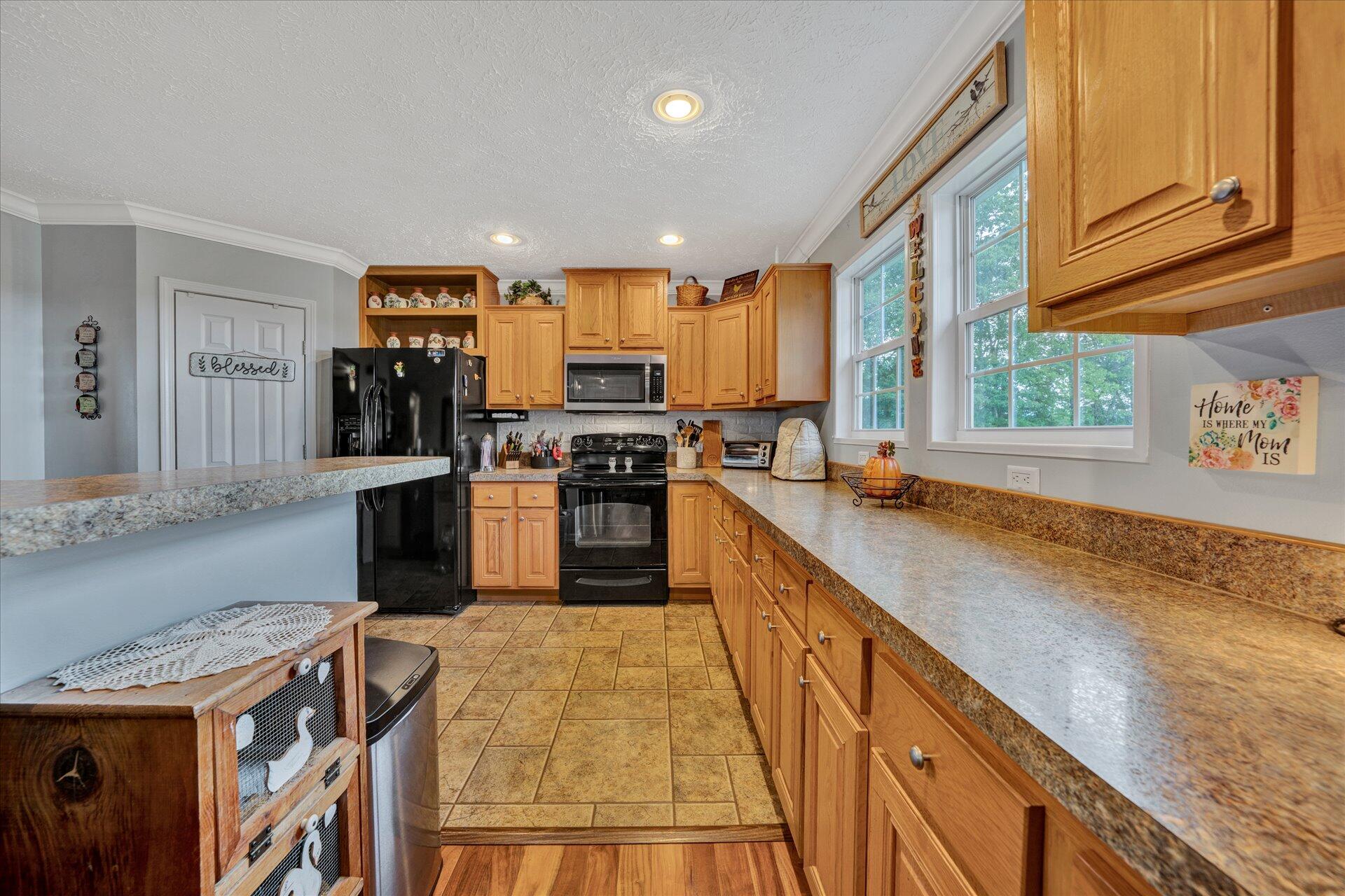 2220 Callaway Road Rocky Mount, VA 24151 - Photo 10 of 22 a kitchen with stainless steel appliances granite countertop wooden cabinets a stove top oven a sink and dishwasher