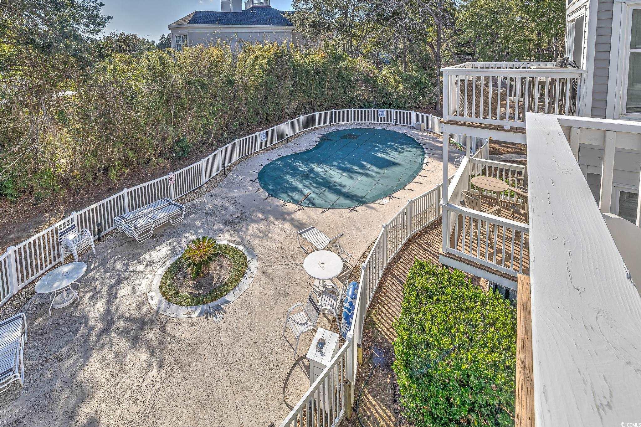 4999 Highway 17 Business, Unit 305 Murrells Inlet, SC 29576 - Photo 16 of 27 View of swimming pool featuring a fenced backyard and a patio area