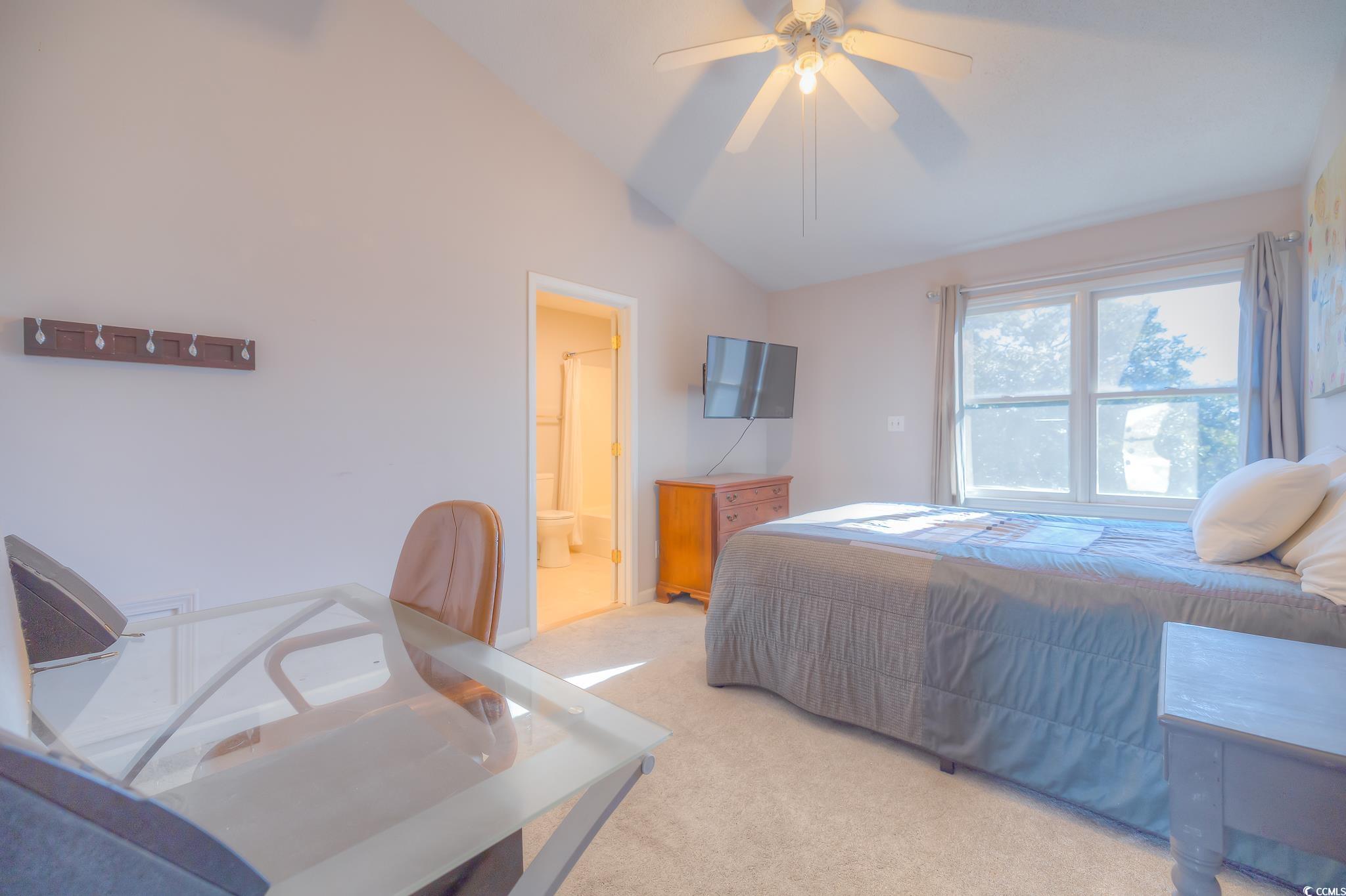 4999 Highway 17 Business, Unit 305 Murrells Inlet, SC 29576 - Photo 22 of 27 Carpeted bedroom featuring lofted ceiling, a ceiling fan, and ensuite bath