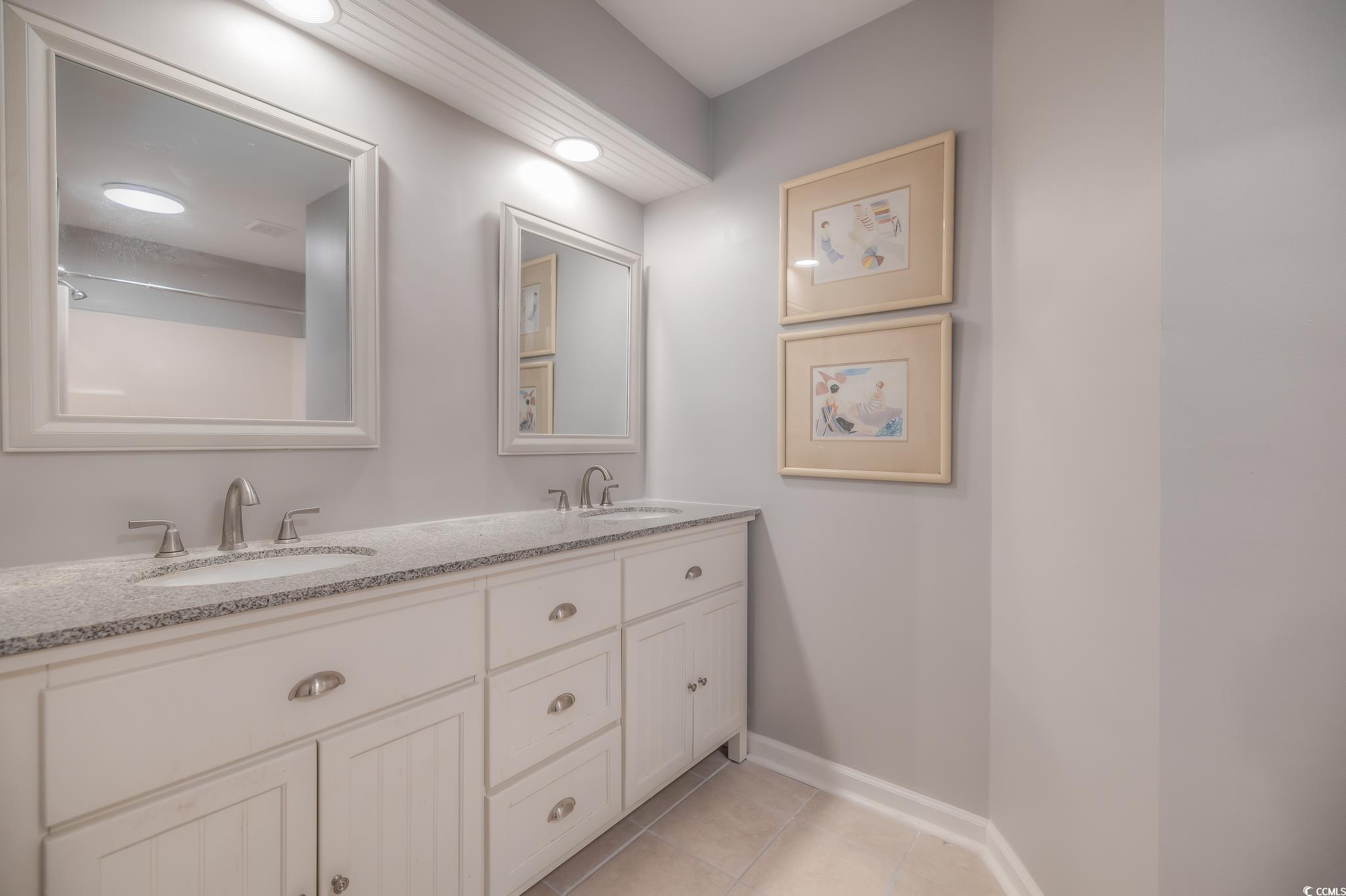 4999 Highway 17 Business, Unit 305 Murrells Inlet, SC 29576 - Photo 24 of 27 Full bathroom with double vanity and light tile patterned floors
