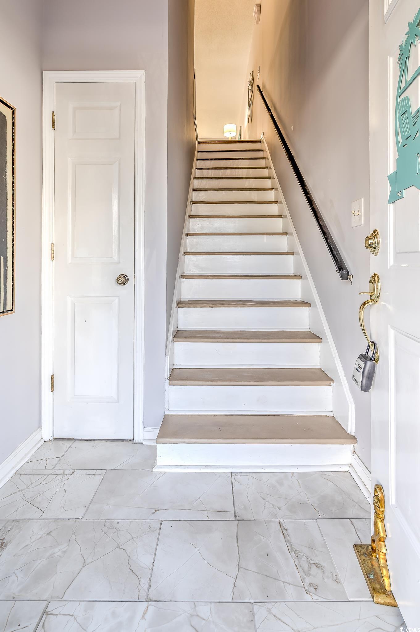 4999 Highway 17 Business, Unit 305 Murrells Inlet, SC 29576 - Photo 6 of 27 Stairs with marble finish flooring and baseboards