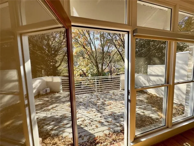a view of a patio with a table and chairs next to a yard
