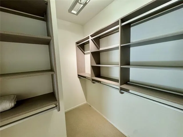 a view of a bedroom with washer and dryer