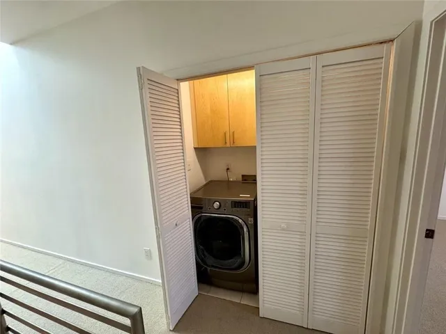 a bedroom with a bed and a lamp next to a window