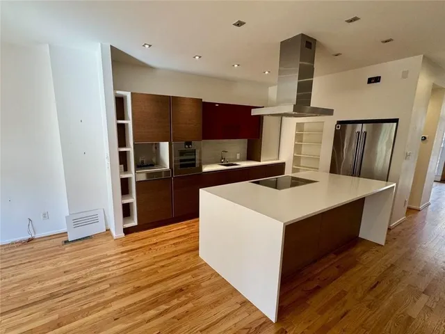 a spacious bedroom with a bed and a fireplace