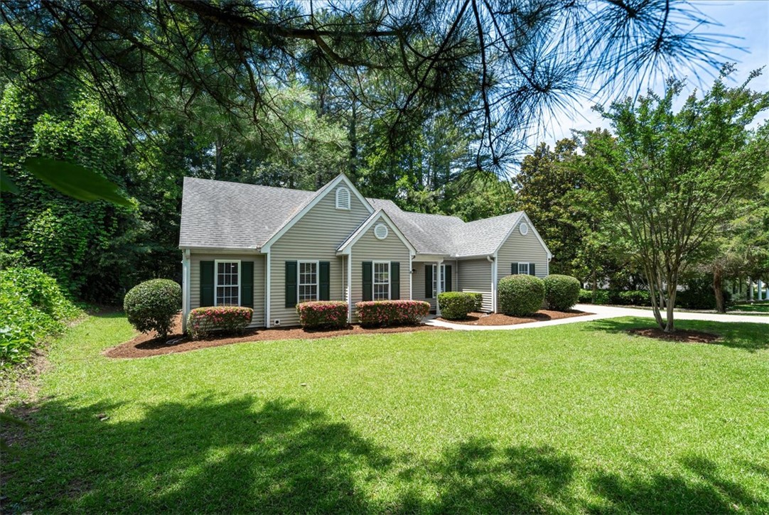212 Blue Ridge Drive Clemson, SC 29631 - Photo 3 of 33 A welcoming residence boasts manicured landscaping and a verdant lawn, framed by mature trees.