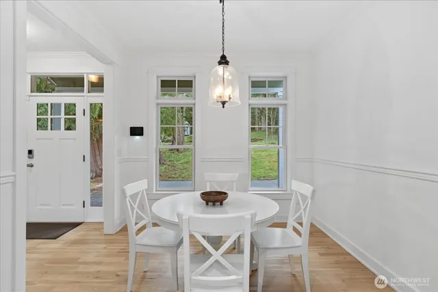 a view of a dining room with furniture and wooden floor