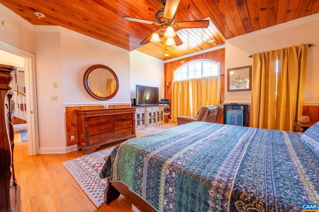 a bathroom with a granite countertop double vanity sink a mirror and a bathtub