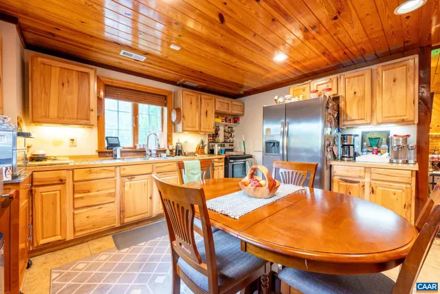 a view of a chair and table in backyard of a house