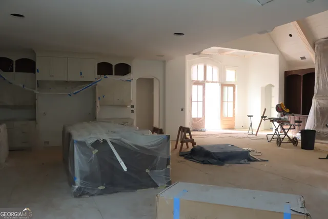 an empty room with a windows and closet