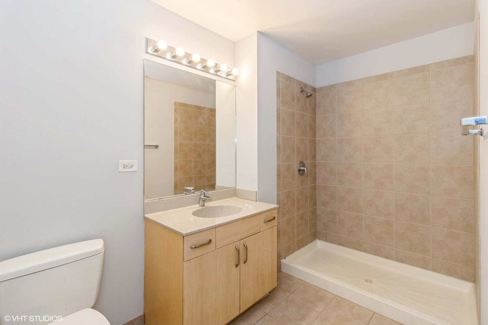 235 West Van Buren Street, Unit 2304 Chicago, IL 60607 - Photo 11 of 13 a bathroom with a sink a toilet and shower