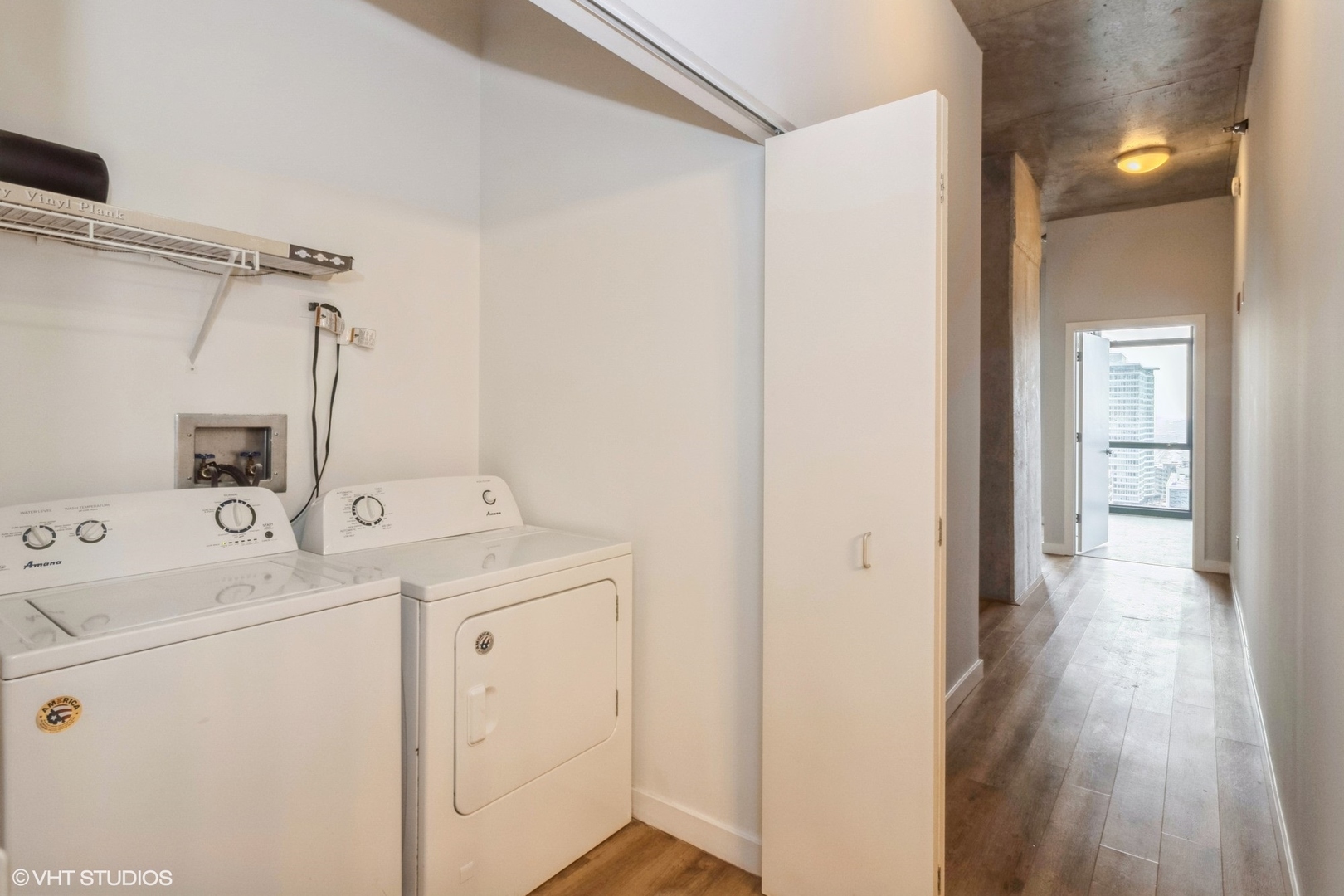 235 West Van Buren Street, Unit 2304 Chicago, IL 60607 - Photo 12 of 13 a view of storage and utility room with washer and dryer