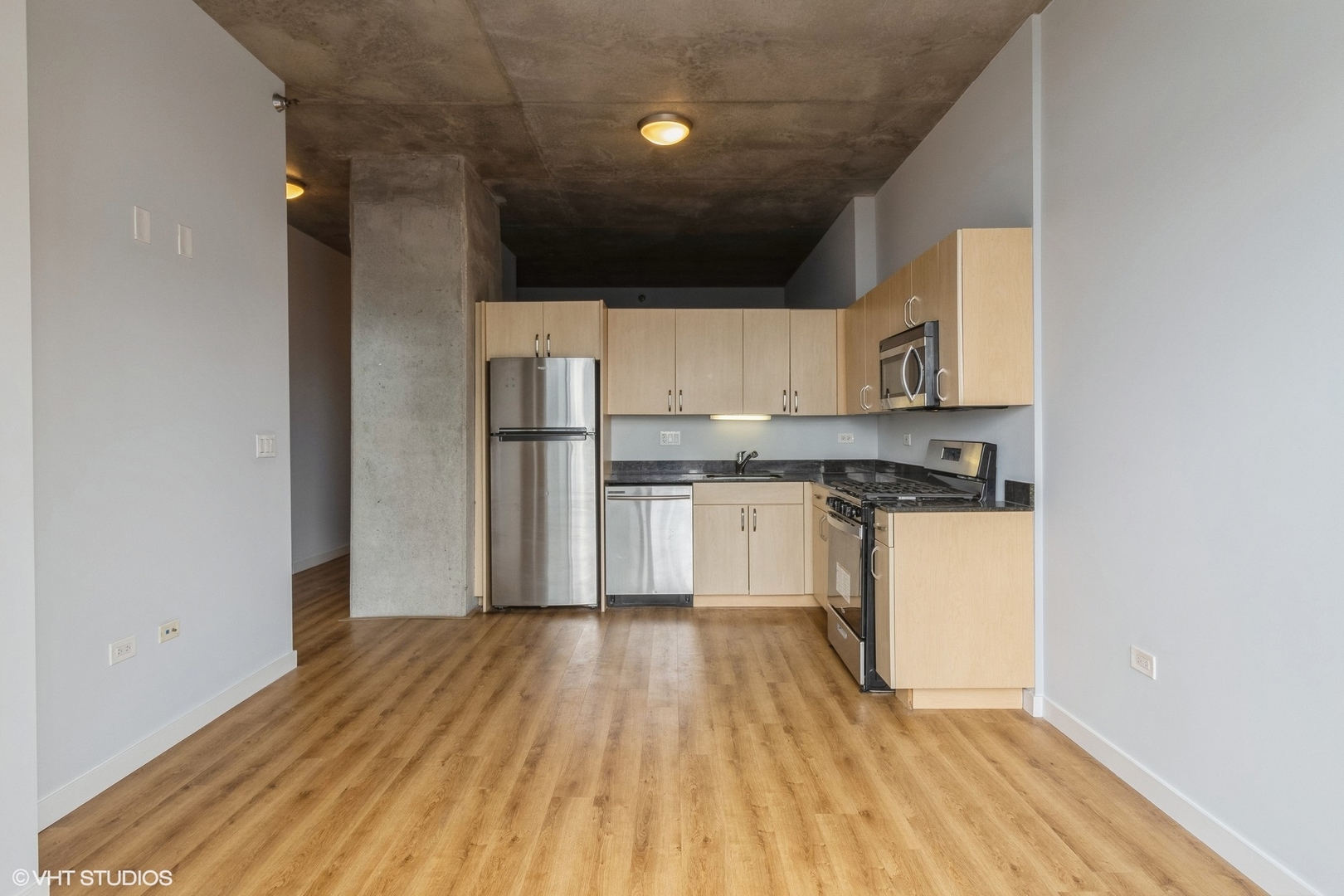 235 West Van Buren Street, Unit 2304 Chicago, IL 60607 - Photo 4 of 13 a kitchen with a refrigerator and white cabinets
