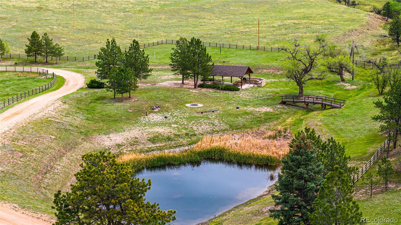 3282 Tomah Road Larkspur, CO 80118 - Photo 10 of 35 a view of a lake with a yard
