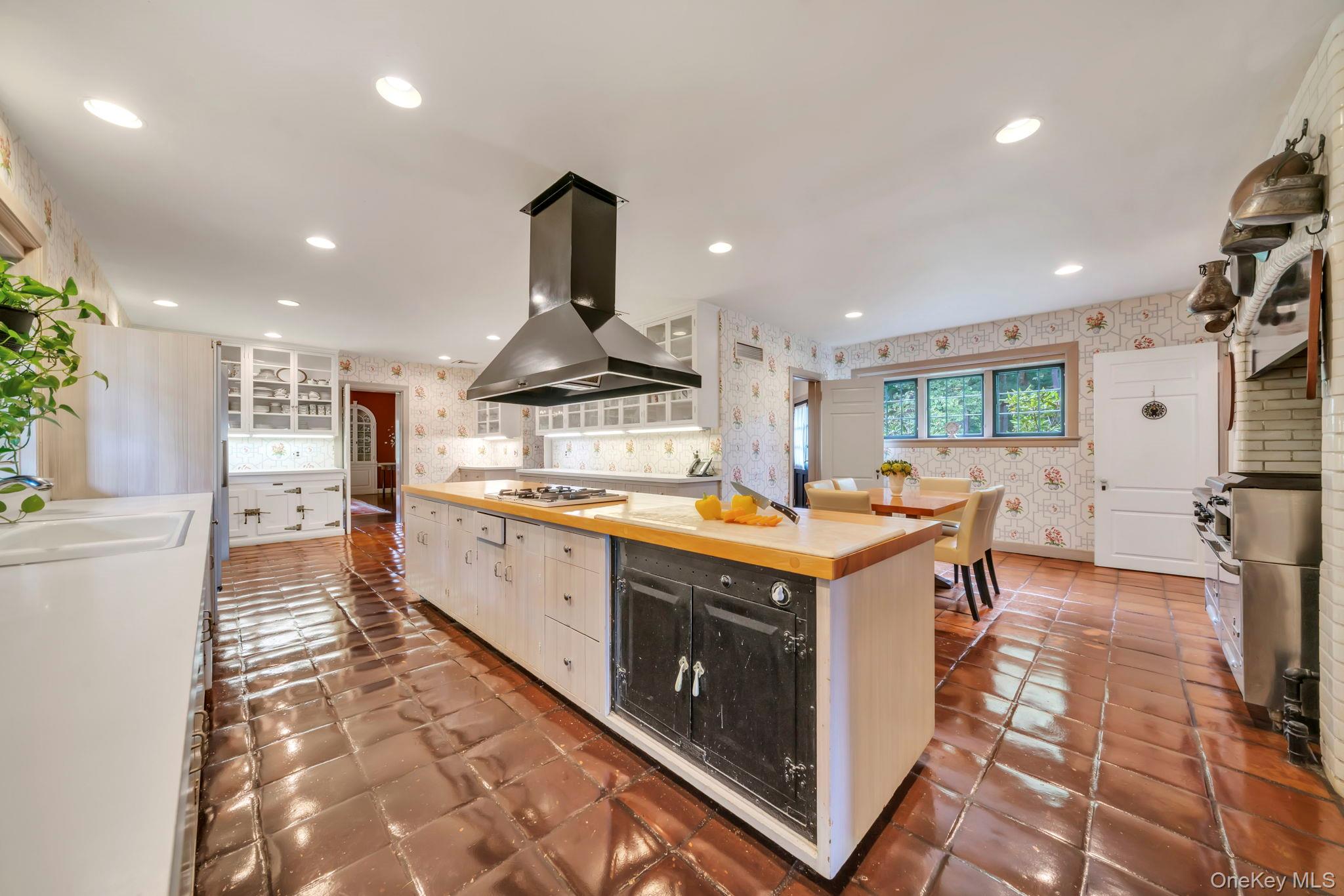 95 Piping Rock Road Locust Valley, NY 11560 - Photo 15 of 39 a kitchen with stainless steel appliances granite countertop a stove and a sink