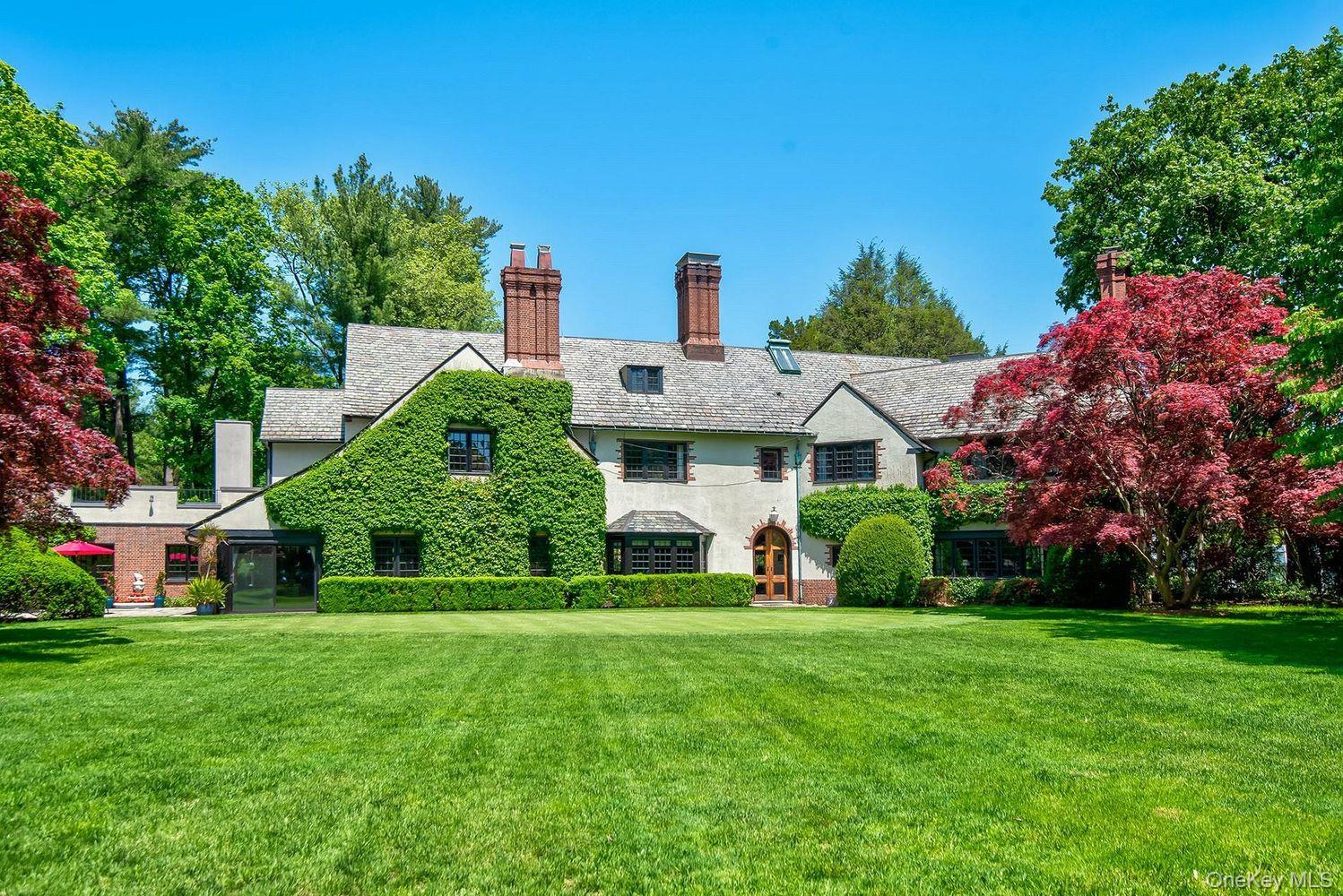 95 Piping Rock Road Locust Valley, NY 11560 - Photo 2 of 39 a front view of house with yard and green space