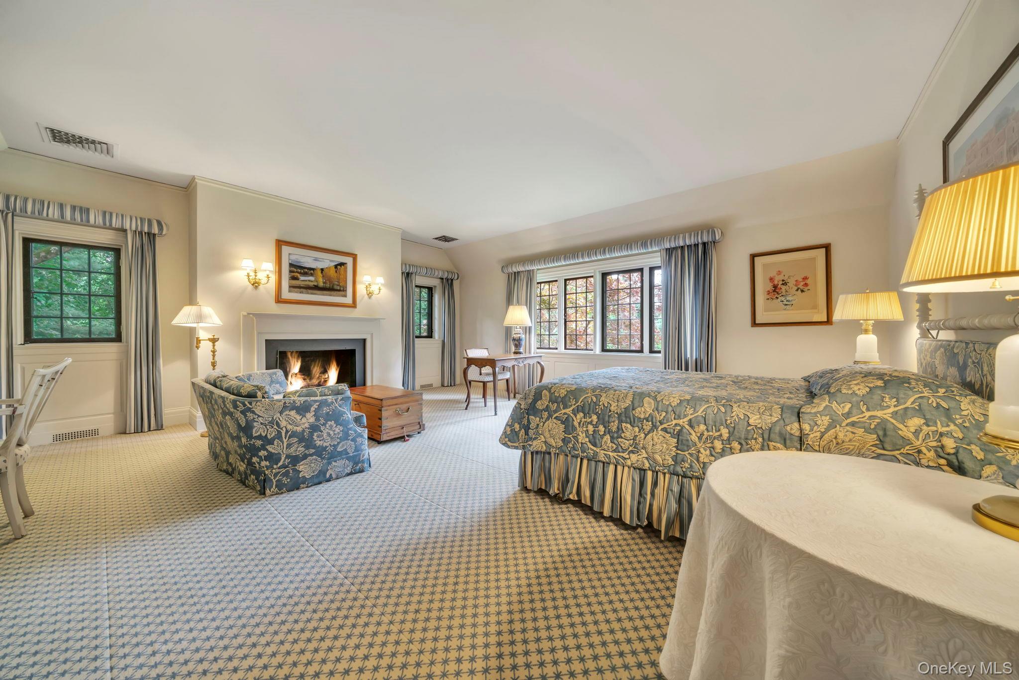 95 Piping Rock Road Locust Valley, NY 11560 - Photo 21 of 39 a bedroom with a large bed and a couch
