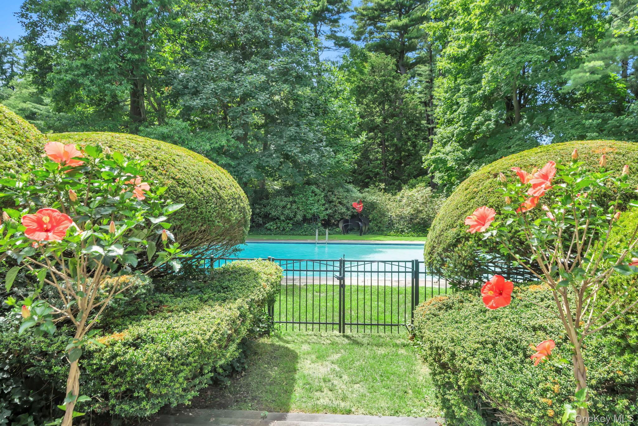 95 Piping Rock Road Locust Valley, NY 11560 - Photo 30 of 39 a view of a garden with flowers
