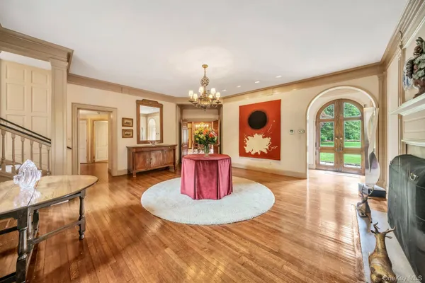 a view of a dining room with furniture a chandelier and wooden floor