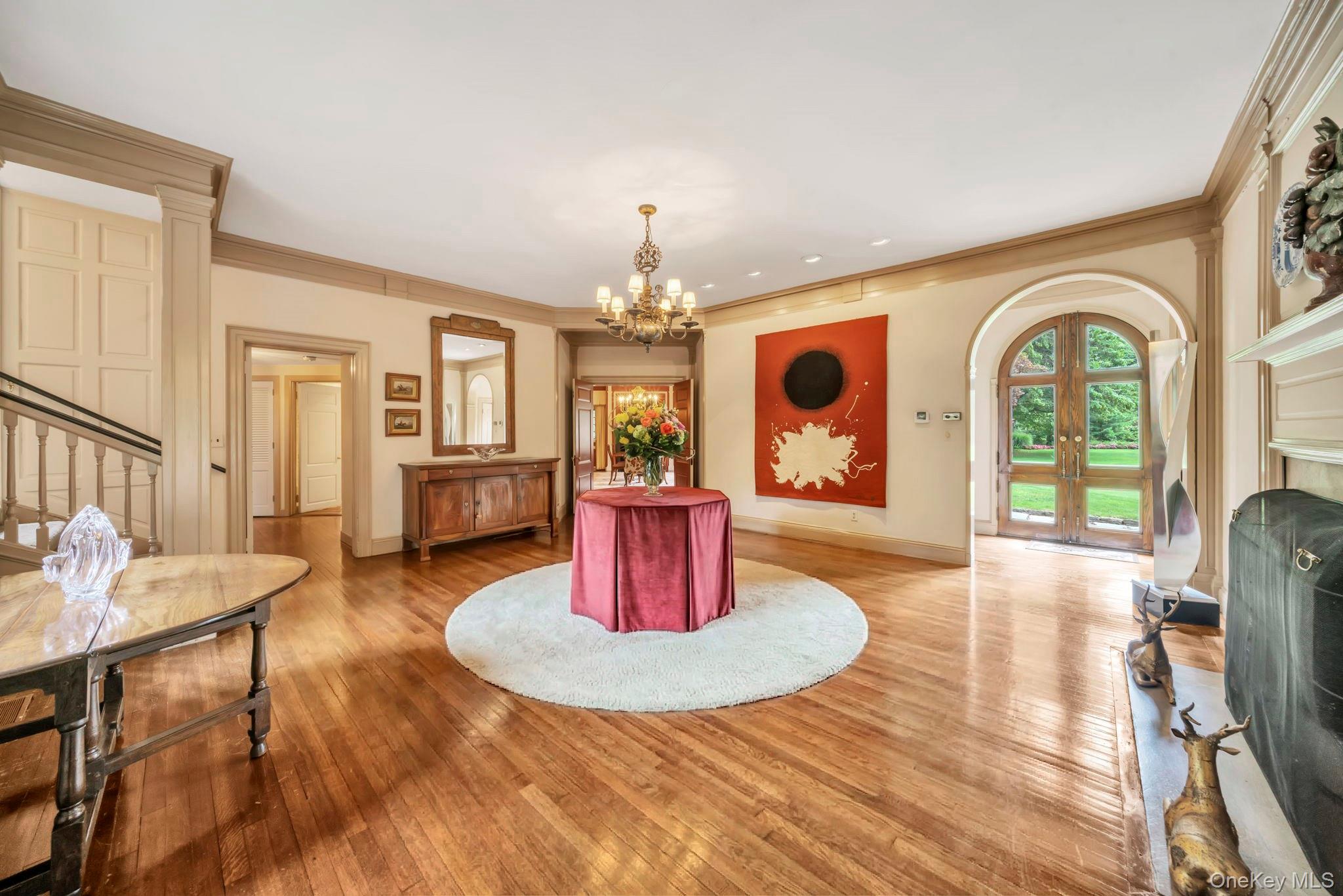 95 Piping Rock Road Locust Valley, NY 11560 - Photo 4 of 39 a view of a dining room with furniture a chandelier and wooden floor