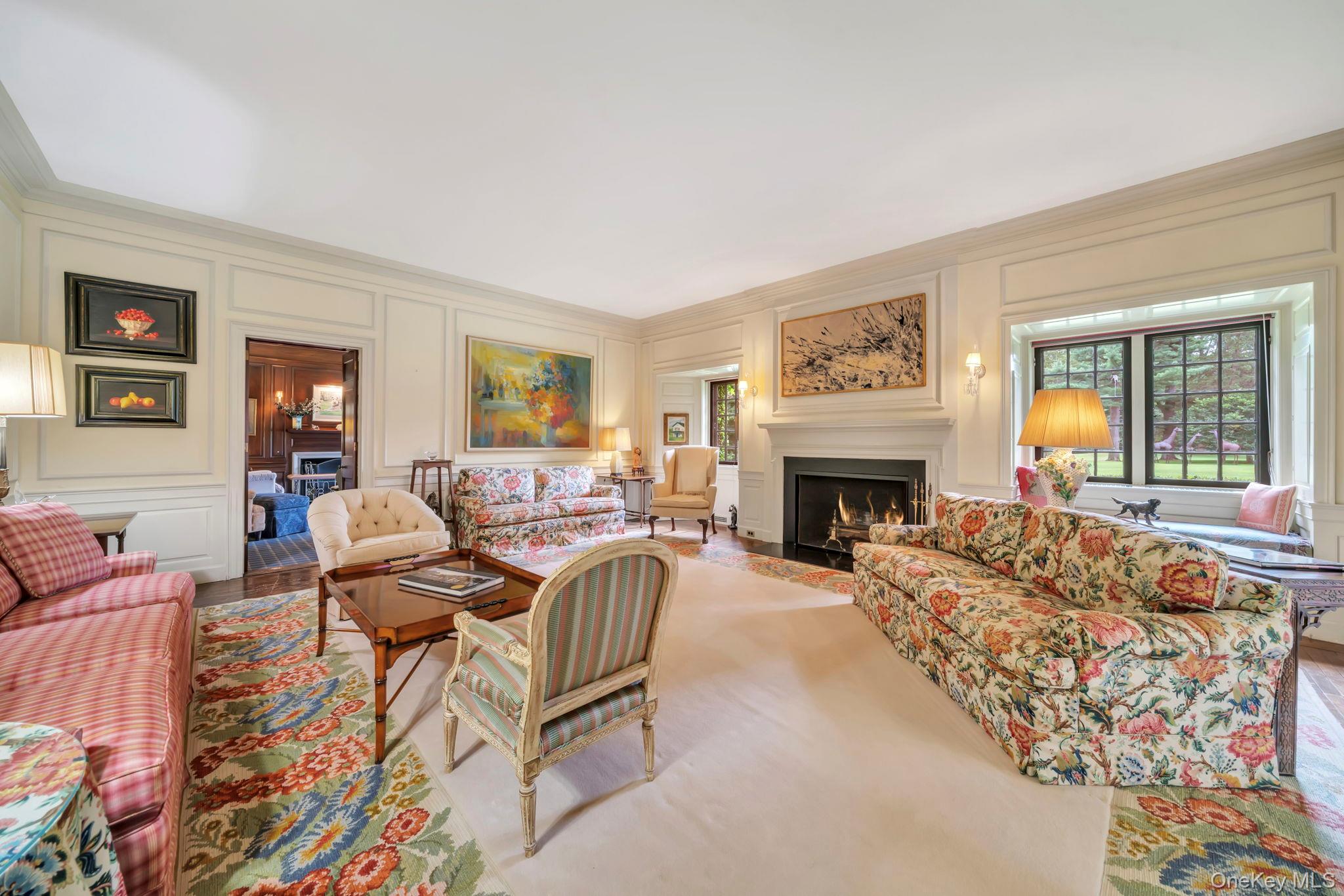 95 Piping Rock Road Locust Valley, NY 11560 - Photo 8 of 39 a living room with furniture large window and a fireplace