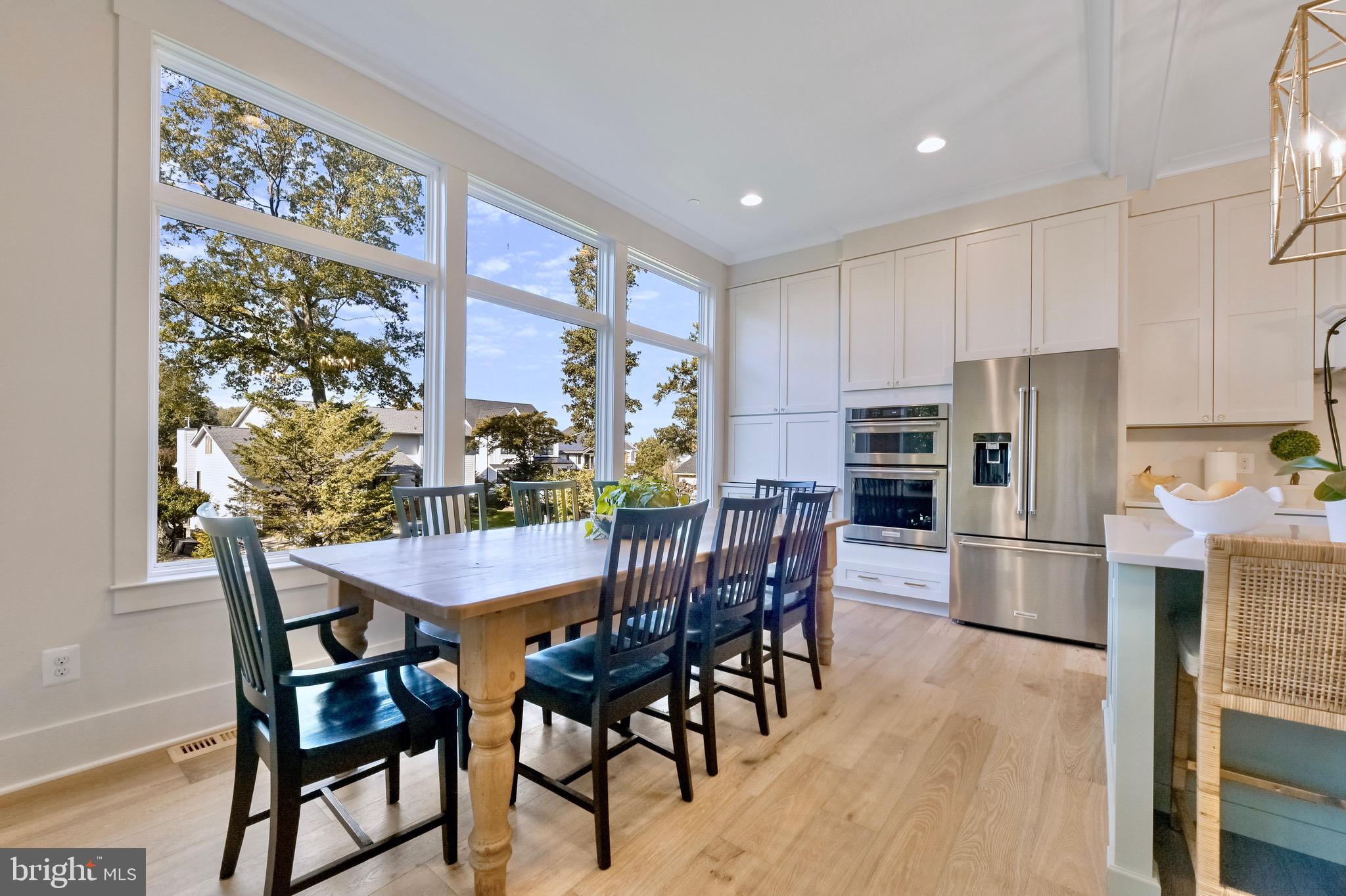 946 Benning Road Galesville, MD 20765 - Photo 11 of 57 a kitchen with stainless steel appliances granite countertop a dining table chairs and granite counter tops