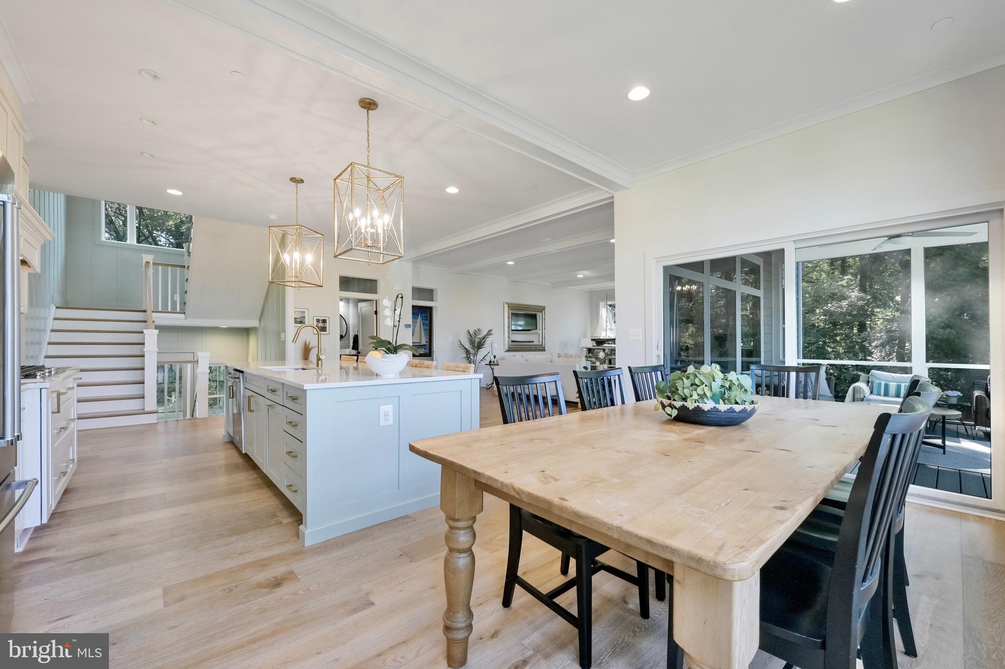946 Benning Road Galesville, MD 20765 - Photo 12 of 59 a view of a dining room and livingroom with furniture wooden floor a chandelier