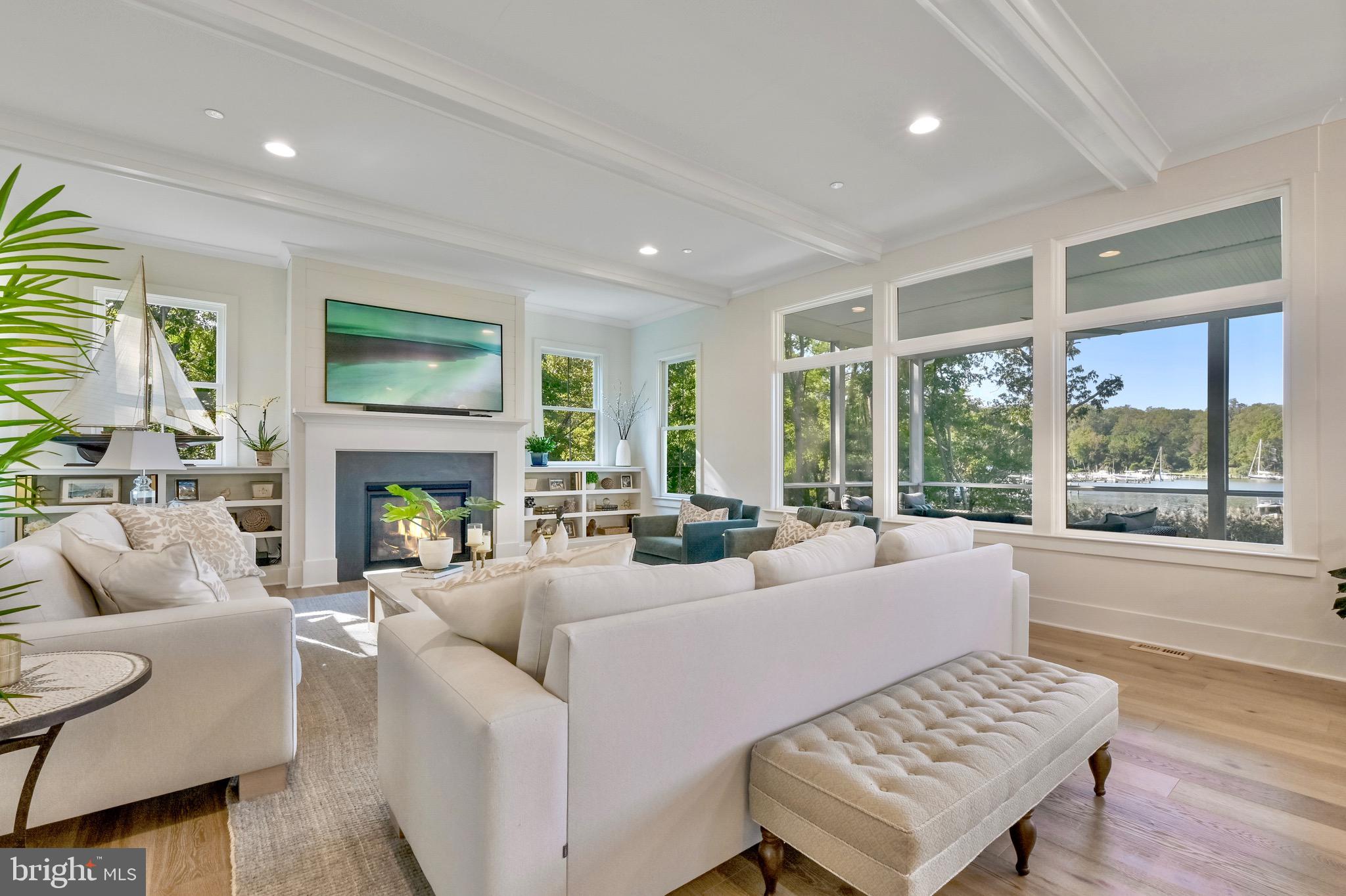 946 Benning Road Galesville, MD 20765 - Photo 15 of 57 a living room with furniture a large window and a fireplace