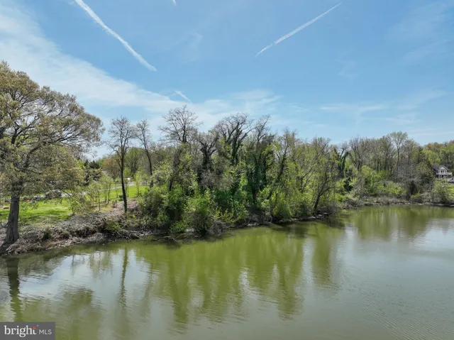 a large kitchen with kitchen island lots of counter space a sink a counter space and stainless steel appliances