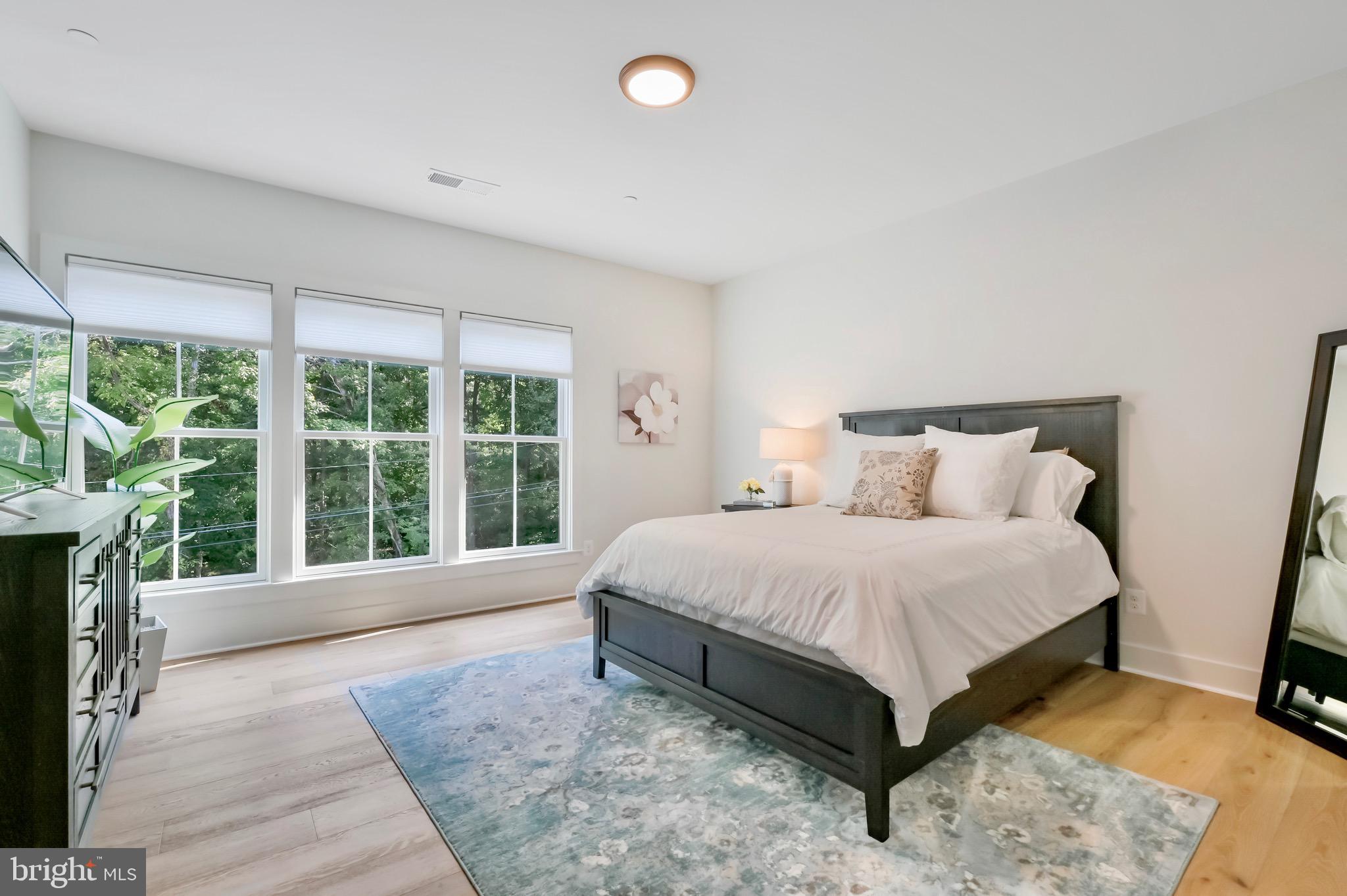 946 Benning Road Galesville, MD 20765 - Photo 22 of 57 a spacious bedroom with a bed and wooden floor