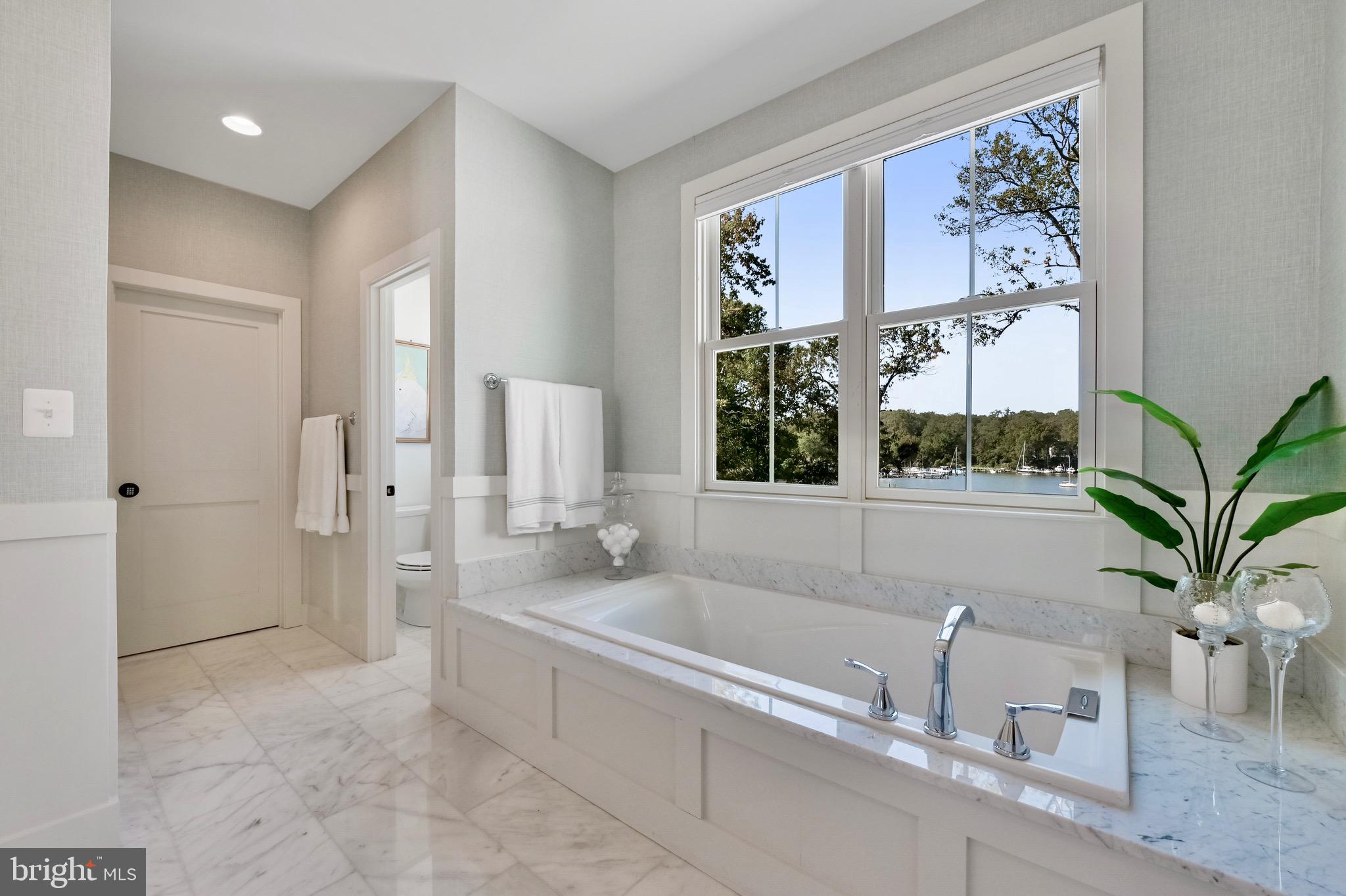 946 Benning Road Galesville, MD 20765 - Photo 29 of 57 a spacious bathroom with a bathtub a sink and a window