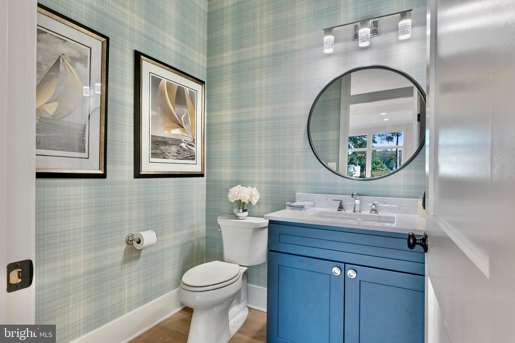 946 Benning Road Galesville, MD 20765 - Photo 30 of 57 a bathroom with a toilet a sink and mirror