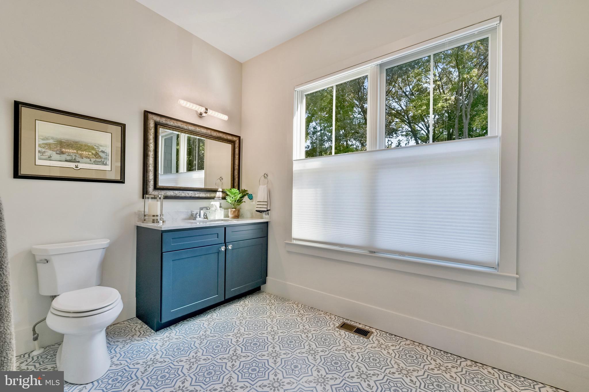 946 Benning Road Galesville, MD 20765 - Photo 33 of 59 a bathroom with a toilet sink and mirror